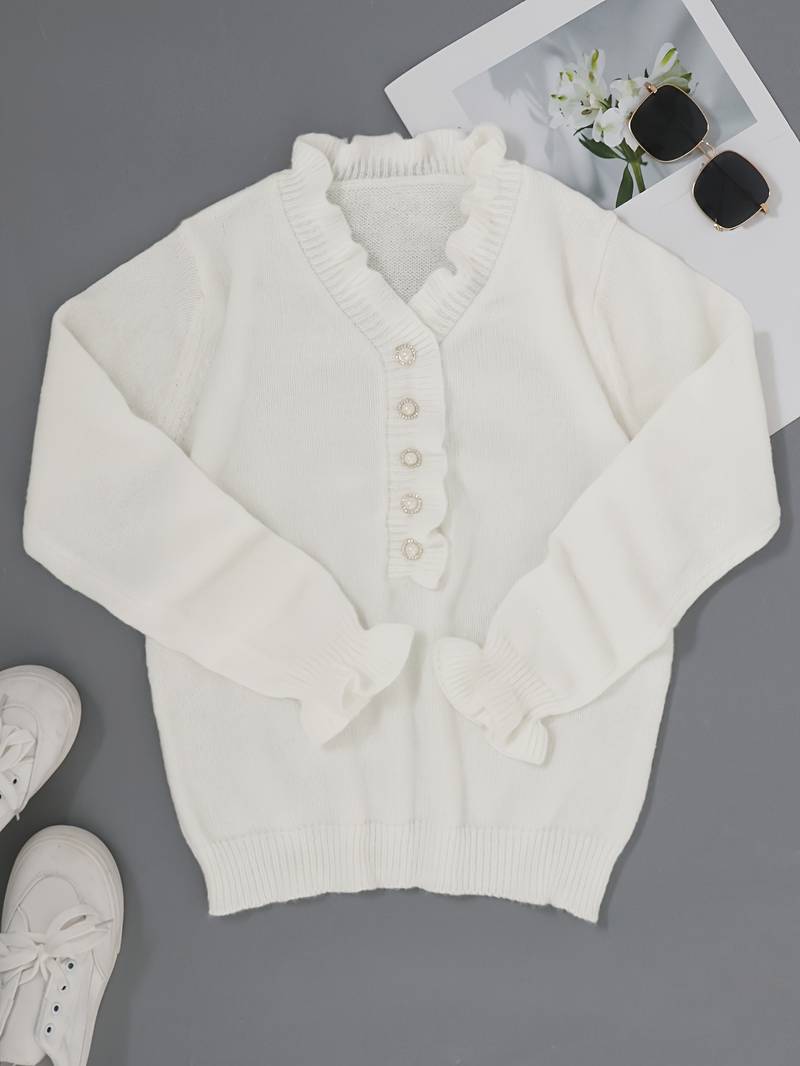 Close-up of a women's blouse showcasing delicate ruffles and intricate decorative buttons.