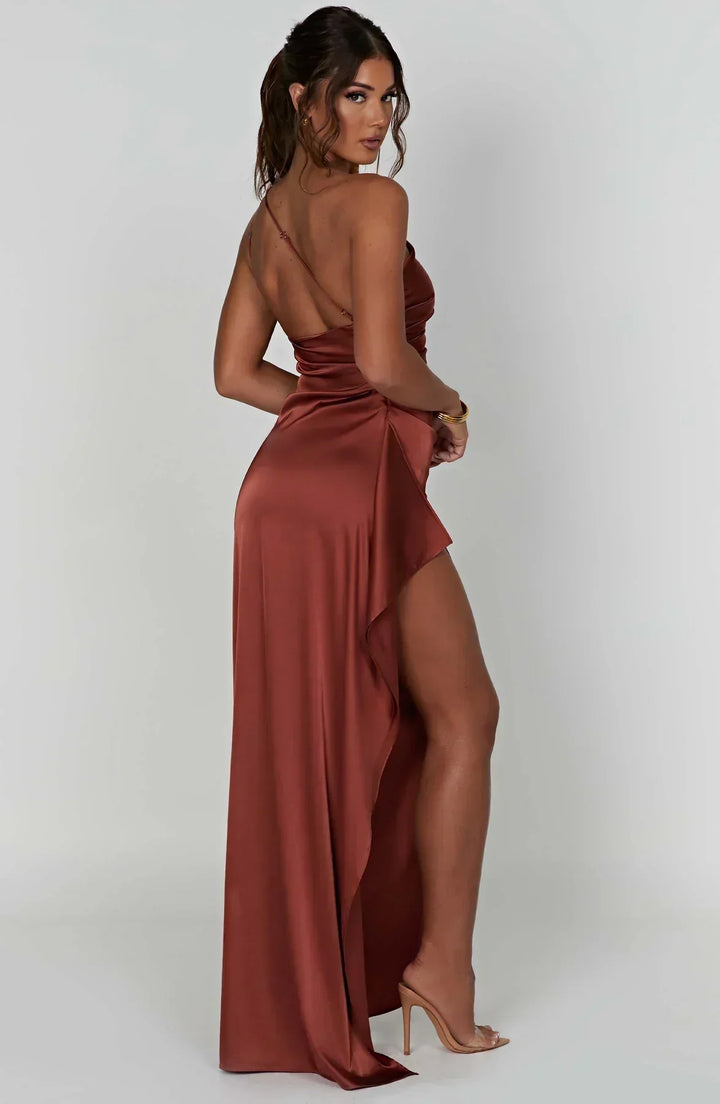 Side profile of a woman showcasing the drape of an asymmetric evening maxi dress