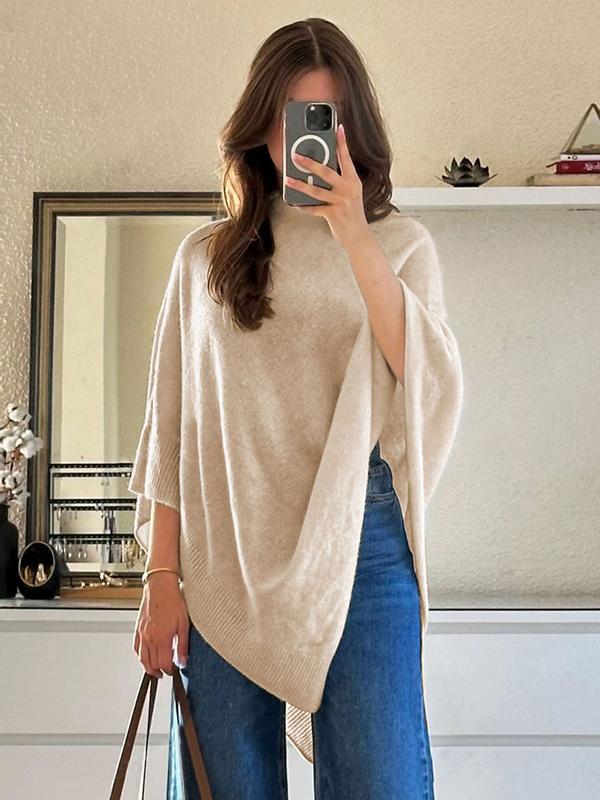 Fashionable women's asymmetrical cape featuring a graceful draped design, ideal as an elegant coverup.