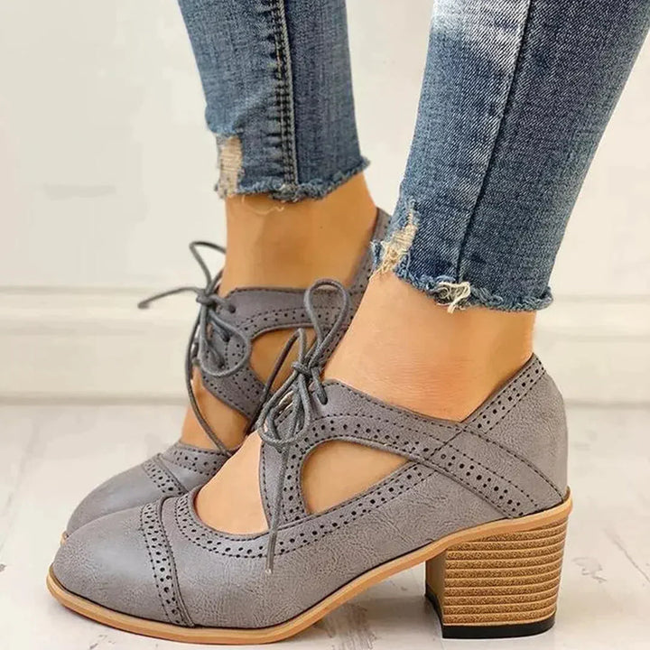 Elegant women's black heeled lace-up T-strap shoes, perfect for formal occasions and versatile styling.