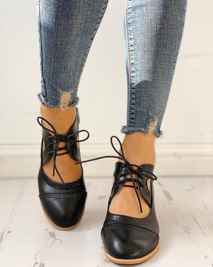 Stylish women's comfort heels: black lace-up T-strap shoes with a chic heel, ideal for dressy wear.