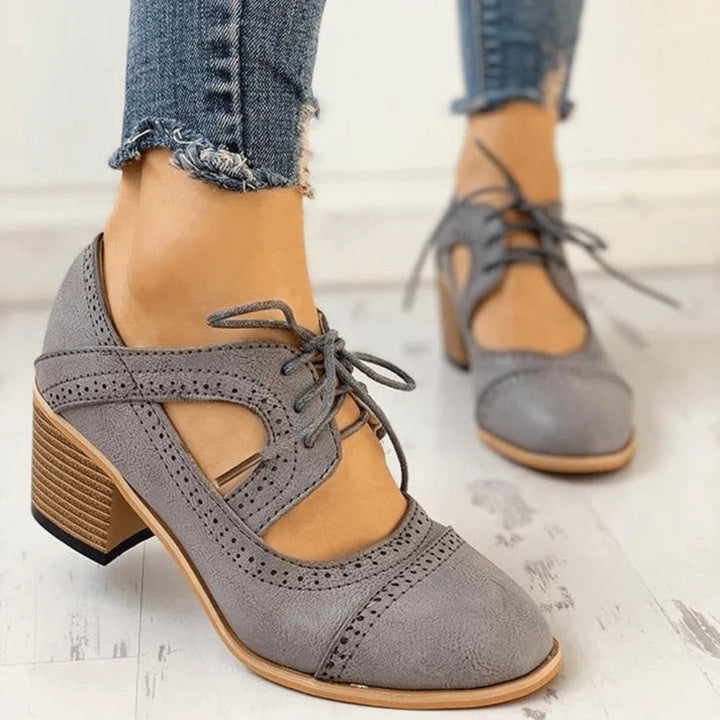 Versatile women's black heeled lace-up T-strap shoes, showcasing their elegant and timeless design.
