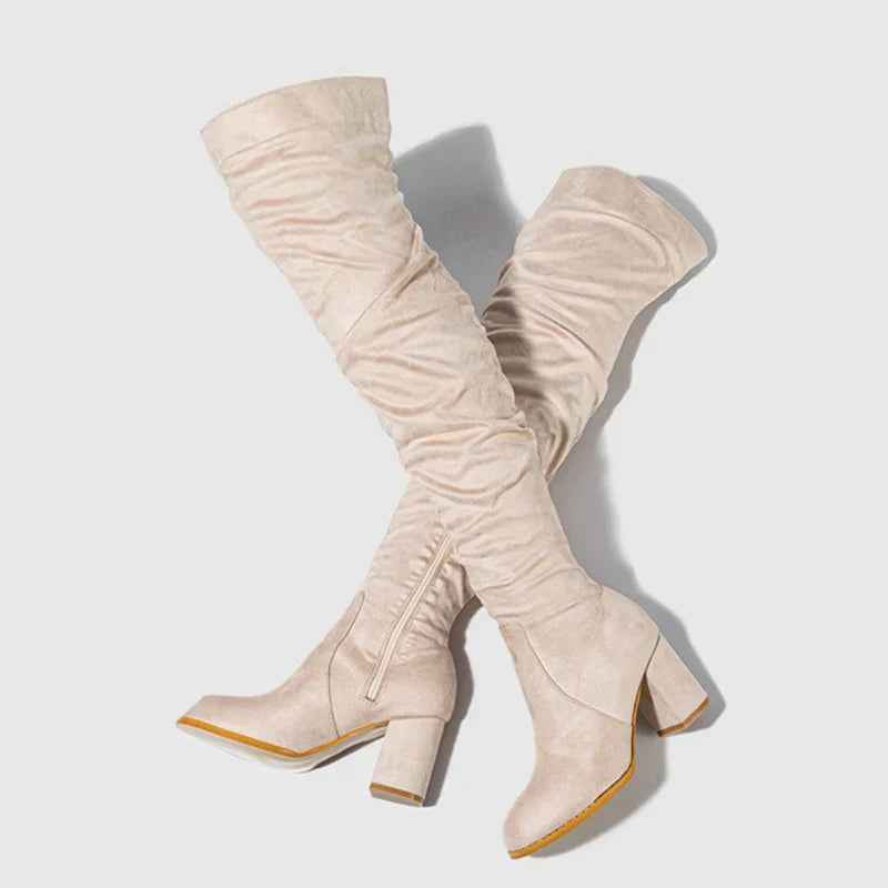 Ankle and foot area of women's heeled tall boots, featuring a pointed toe design