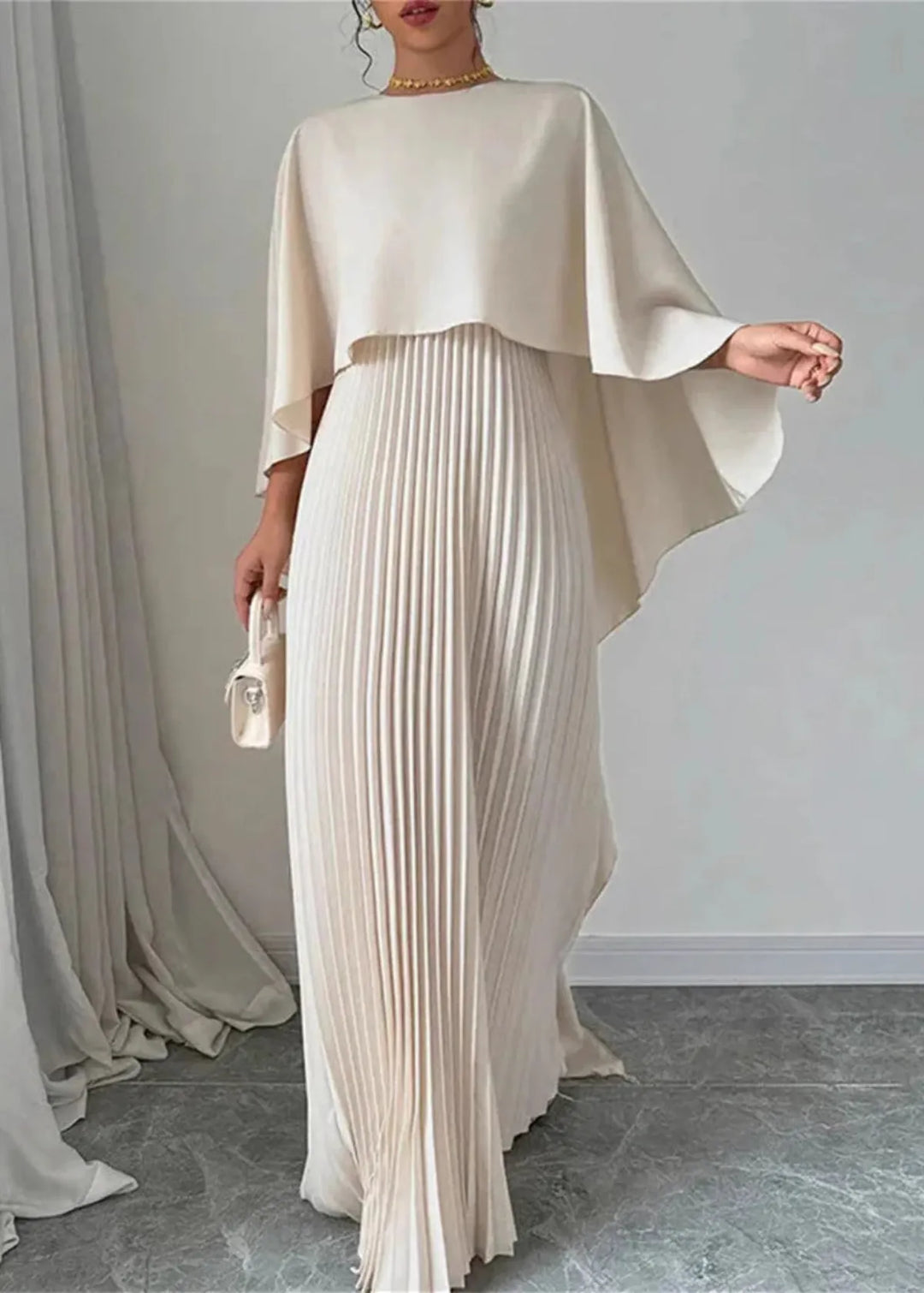 Elegant women's black tie cape overlay pleated maxi dress, perfect for a wedding guest or formal evening occasion.