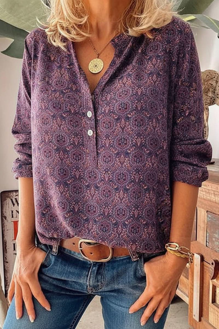 Women's long sleeve blouse featuring an elegant vintage print design. Stylish button-front top for fashion-forward women.