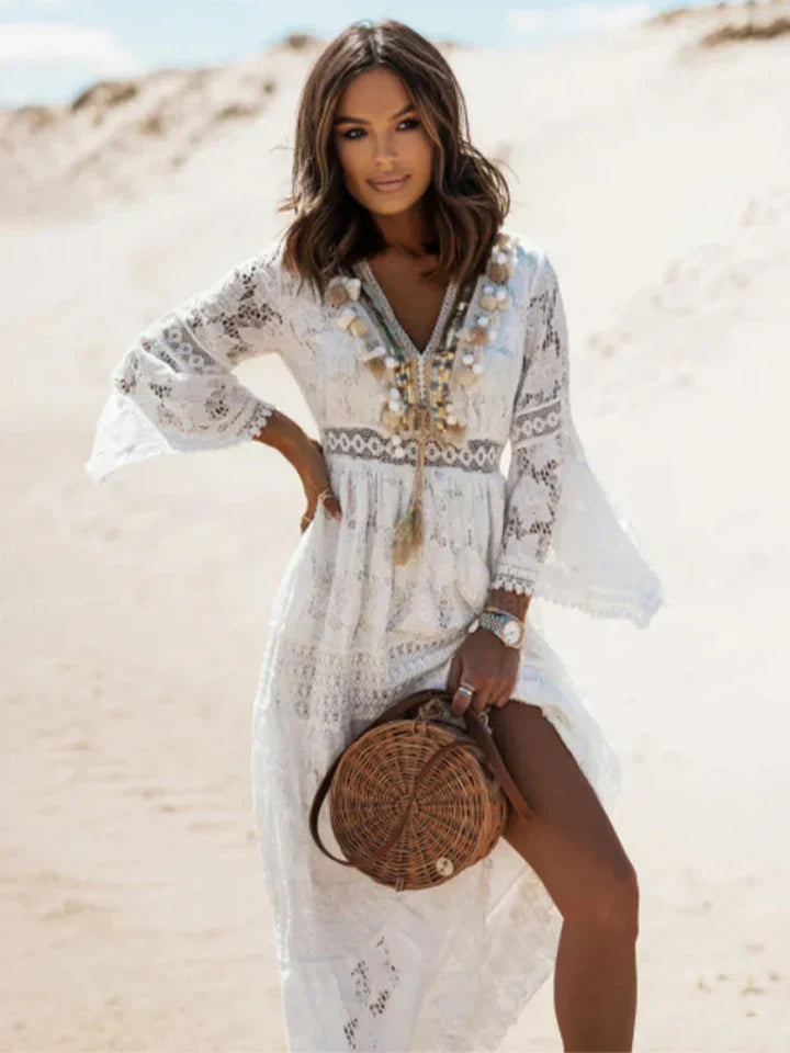 Flowy white bohemian maxi dress for women, featuring elegant lace and chic flared sleeves, ideal for spring & summer.