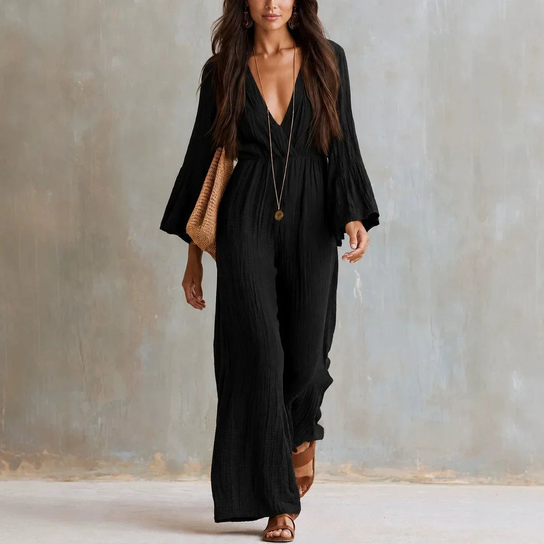 Fashionable women's wide leg jumpsuit with a deep V-neck and flowy flare sleeves, ideal for bohemian summer style.