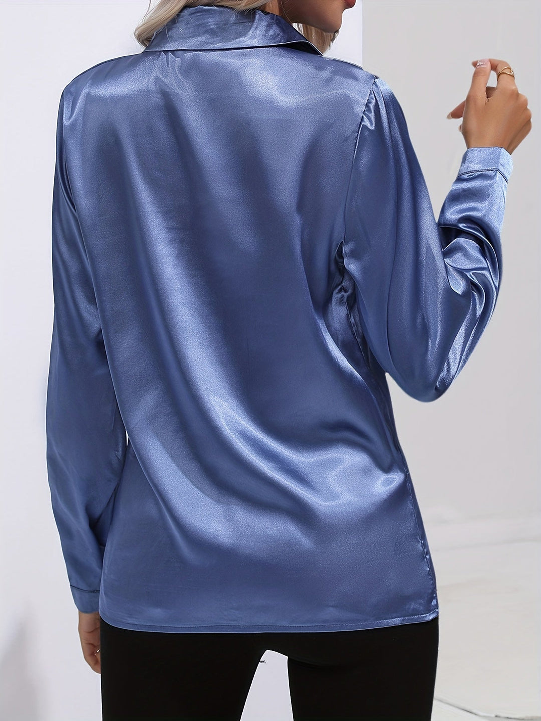 Stylish black long-sleeve satin button-down blouse for women, a versatile piece for both formal and casual settings.