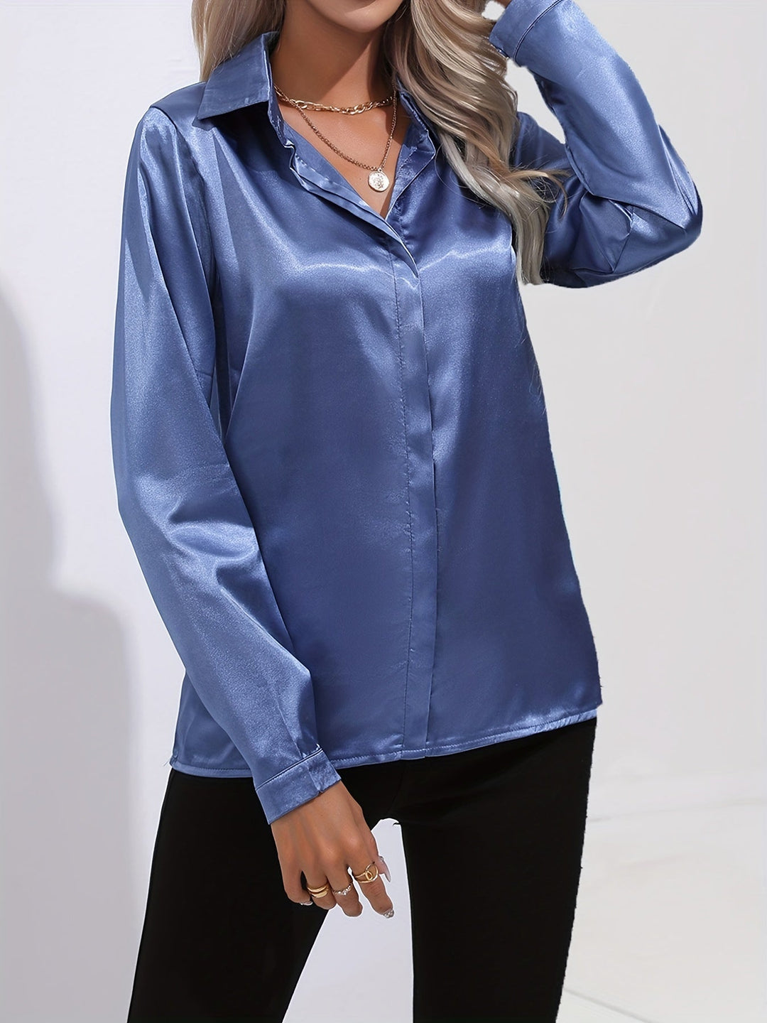 Formal wear: a women's button-down long-sleeve satin blouse in emerald green, suitable for business meetings.