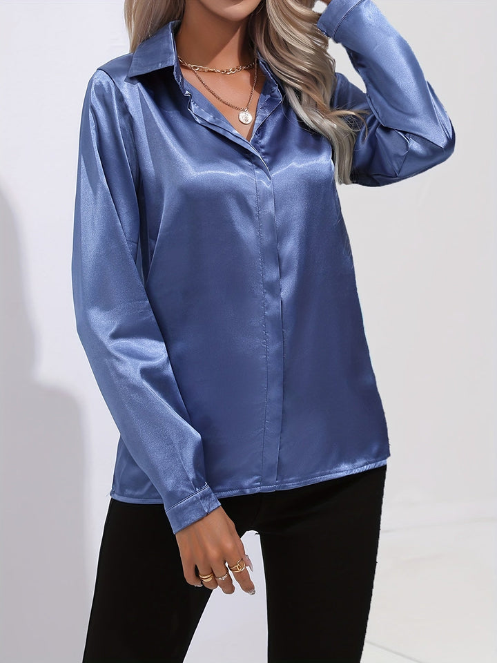 Formal wear: a women's button-down long-sleeve satin blouse in emerald green, suitable for business meetings.