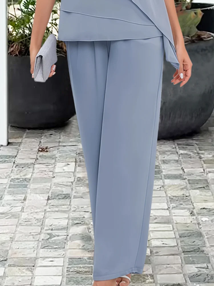 Light blue & navy formal two-piece set with a chic cape top & straight leg pants for wedding guests.