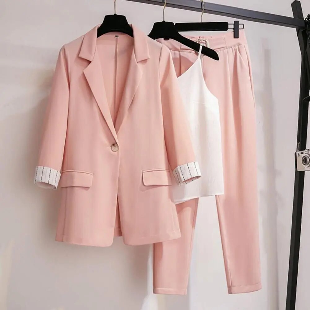 Full-body view of a woman wearing a modern and elegant coordinated blazer, pants & top set, ideal for formal occasions.