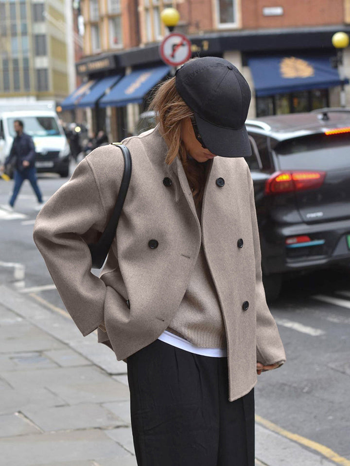 Classic gray double-breasted coat for women, showcasing sophisticated and tailored outerwear style.
