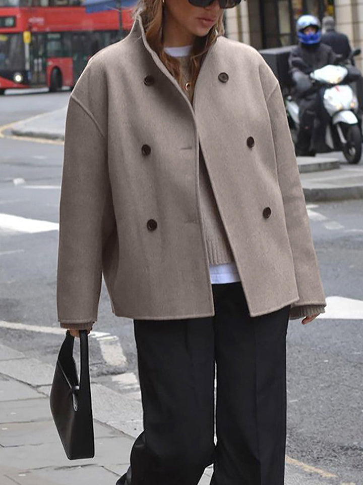 Full-length view of an elegant women's khaki double-breasted coat, perfect for chic winter layering.