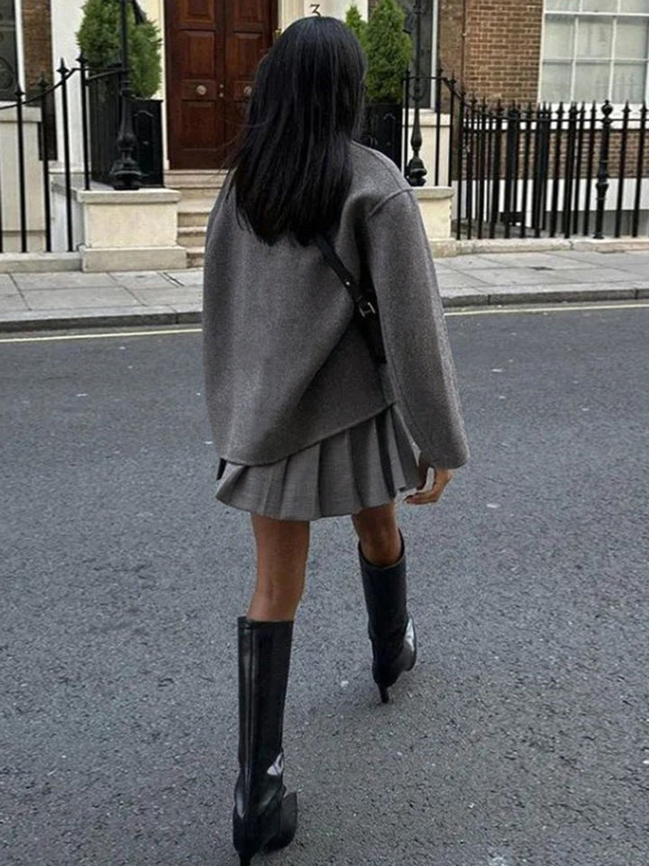 Fashionable women's double-breasted coat in gray, a classic and chic outerwear essential for winter.