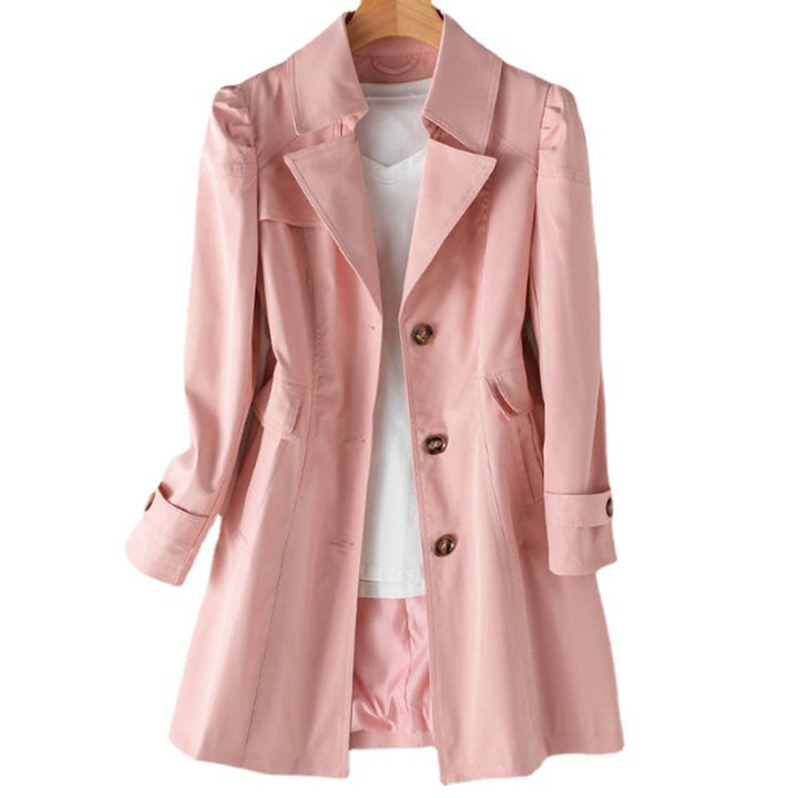 Full-length view of a woman wearing a beige classic double-breasted trench coat, ideal for spring outerwear.