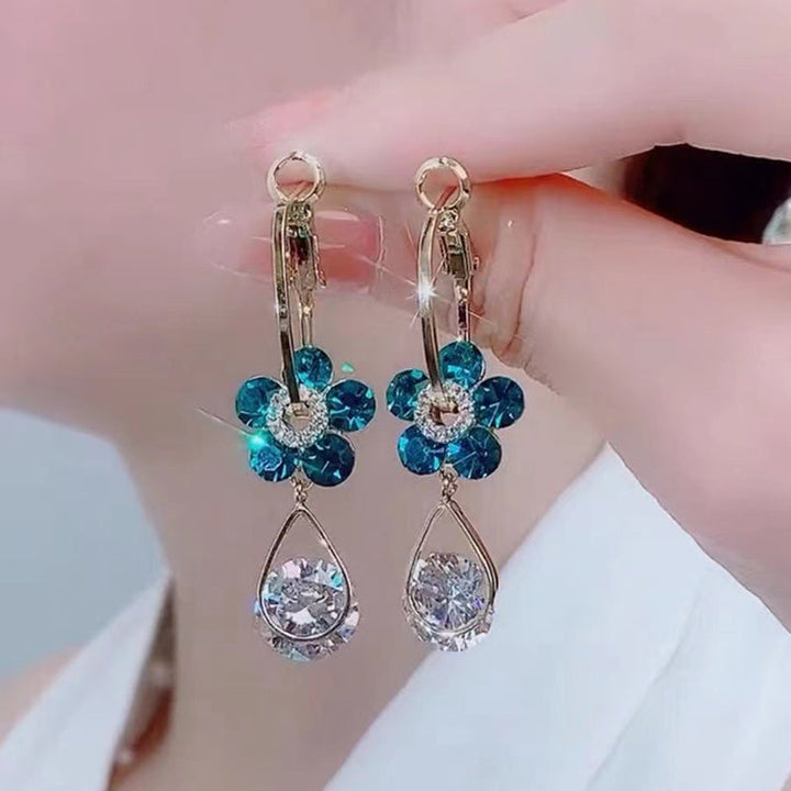 Women's silver-tone earrings with intricate crystal flower design, a chic and casual accessory