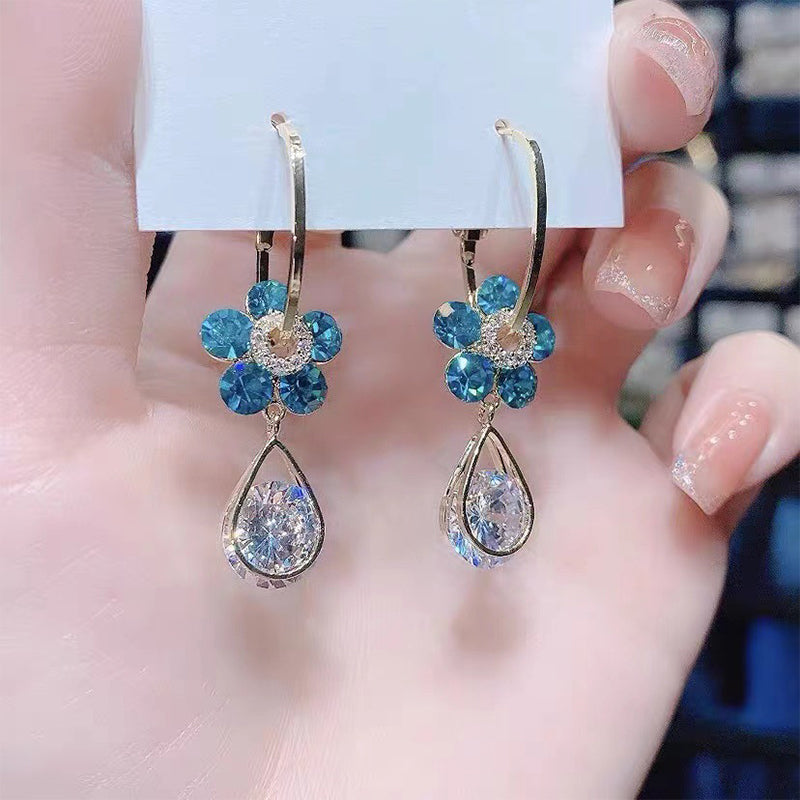 Beautiful women's flower earrings adorned with shimmering crystals, a lovely fashion statement