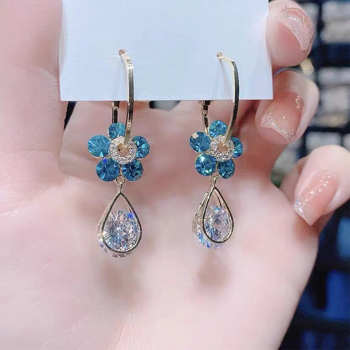 Beautiful women's flower earrings adorned with shimmering crystals, a lovely fashion statement