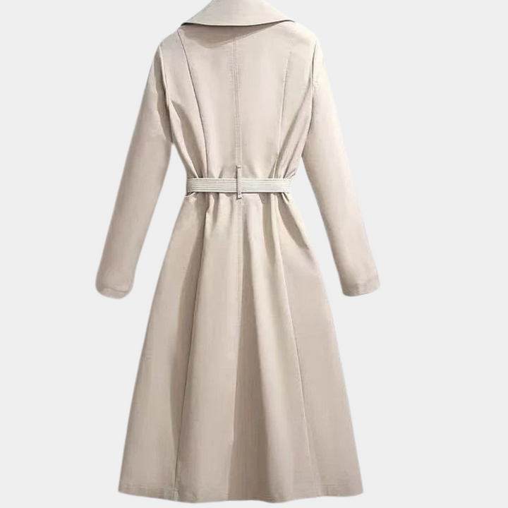Classic women's trench coat with double-breasted front, belt, and scarf detail, ideal winter outerwear.