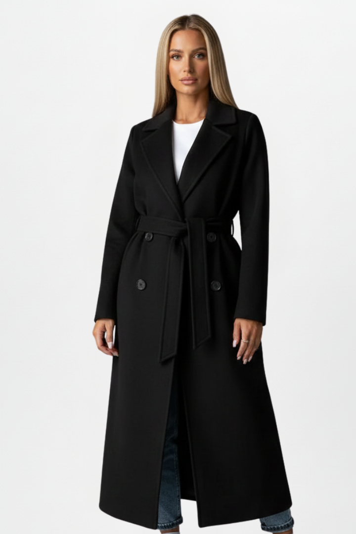 Fall & winter fashion: Women's elegant double-breasted long coat with a stylish belt. Classic outerwear style.
