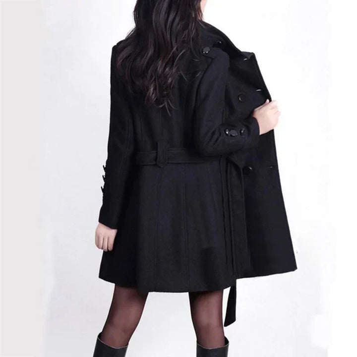 Stylish long double-breasted trench coat for women, featuring a belted design for elegant fall and winter outerwear.