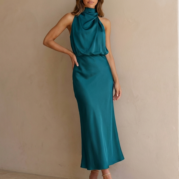 Flowy women's cocktail midi dress featuring a draped halter neck and a chic blouson waist design.