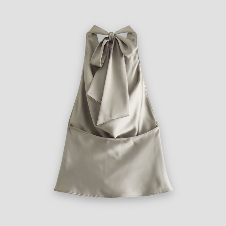 Mannequin displaying a women's elegant draped halter satin top in a classic champagne color.