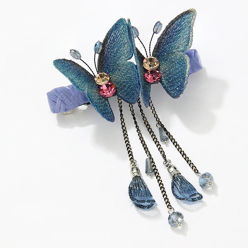 Stylish women's hair clip, embroidered butterfly design with fringe accent, suitable for party hairstyles.