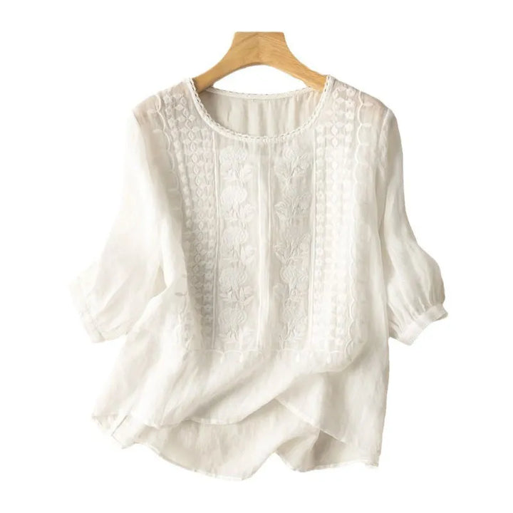 Elegant women's embroidered puff sleeve blouse with floral details, a chic high-low hem & round neck for spring/summer.