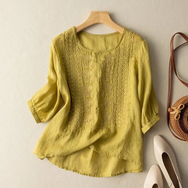 Women's round neck embroidered blouse with stylish puff sleeves & modern high-low hem; perfect for casual elegance.