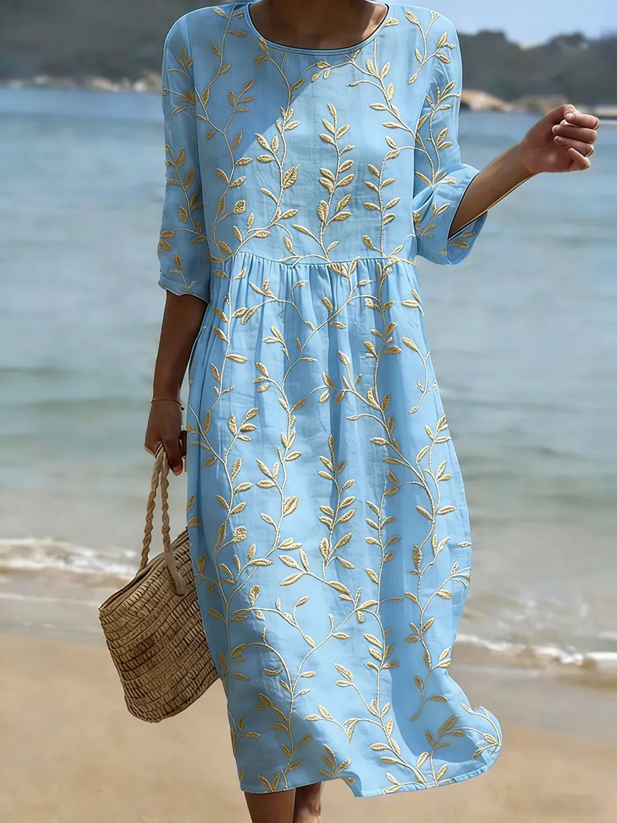 Elegant women's embroidered smock midi dress with 3/4 sleeves, featuring a beautiful leaf and vine pattern. Summer style.