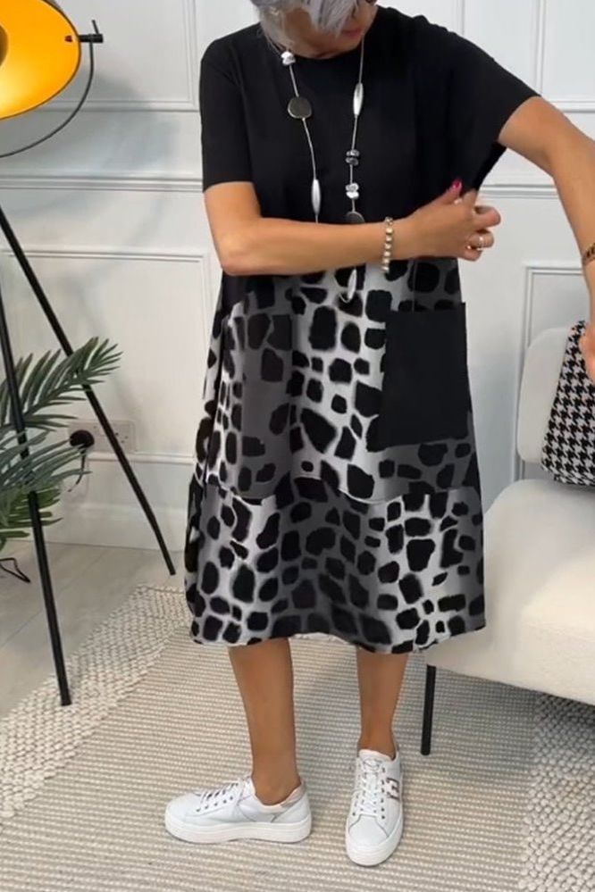 Sophisticated women's flowy midi dress, featuring a beautiful floral pattern and flattering cinched waist.