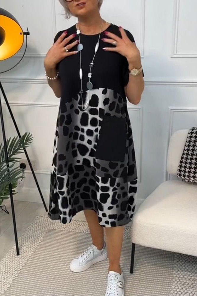 Casual yet elegant women's floral midi dress, ideal for spring/summer, with a cinched waist.