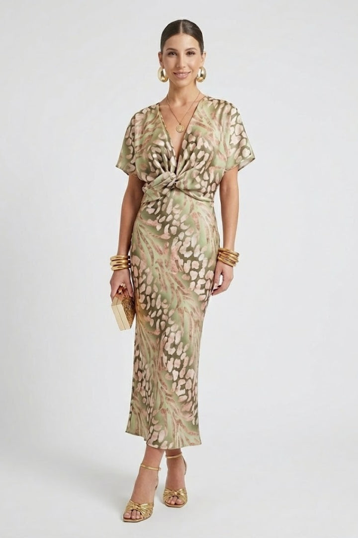 Green floral midi dress for women featuring a V-neck, short sleeves, and an elegant pleated hem. Ideal for spring.