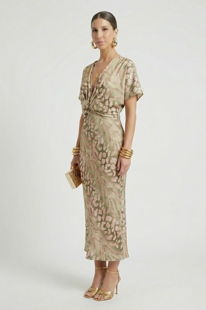 Vibrant floral print women's midi dress with a flowing pleated hem and flattering short sleeves. Daytime spring outfit.