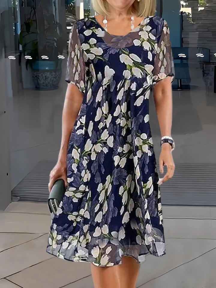 Elegant women's floral midi dress with round neck & short sleeves. Perfect A-line summer casual daywear.