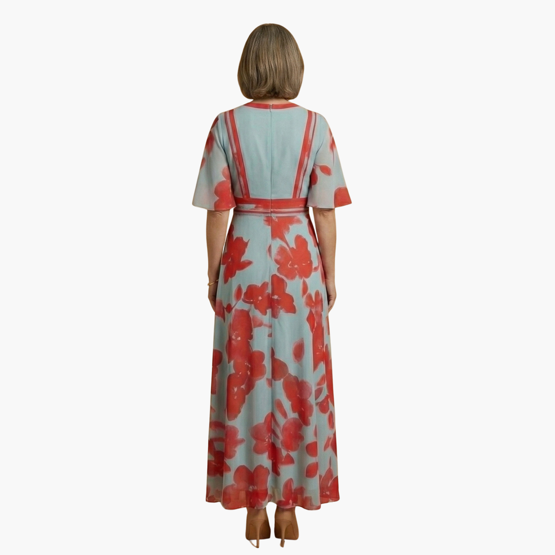 Back view of a flowing elegant floral V-neck maxi dress for women. Stylish summer fashion.