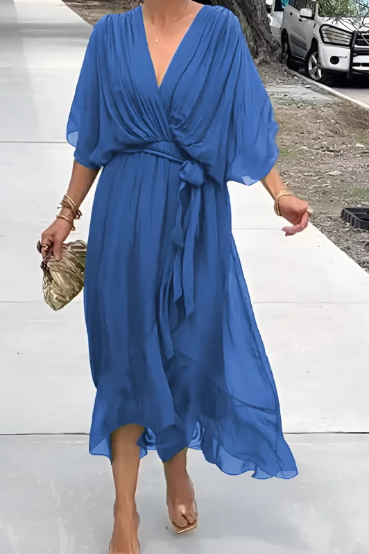 Rear view of women's elegant flowing maxi dress, showcasing its graceful movement. A comfortable long evening dress.