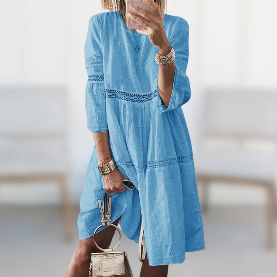 Flowy elegant midi dress for women, great for summer vacations or chic spring fashion. Comfortable round neck.