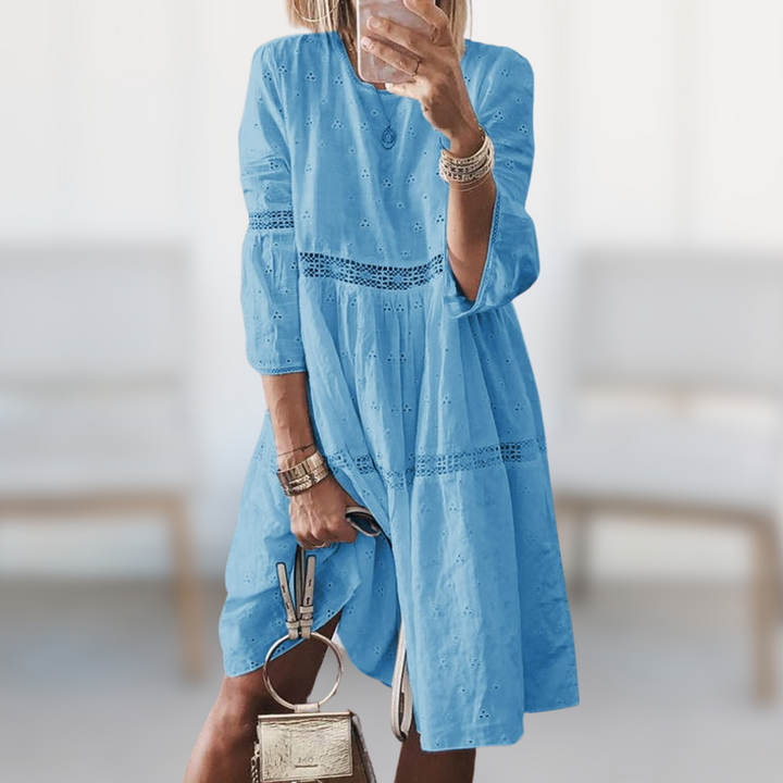 Flowy elegant midi dress for women, great for summer vacations or chic spring fashion. Comfortable round neck.