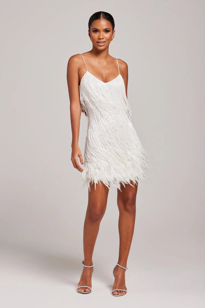 Model wearing a stylish black fringe feather cocktail dress, showcasing its elegant silhouette.