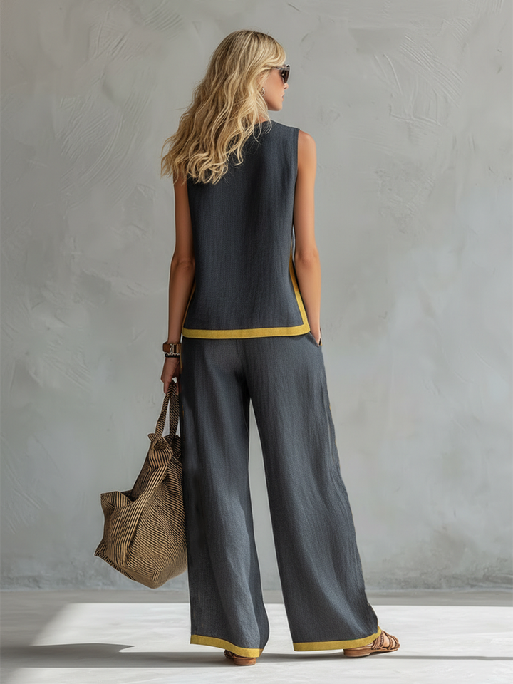 Stylish women's gray vest and matching trousers. Versatile two-piece outfit perfect for work, casual, or elegant events.