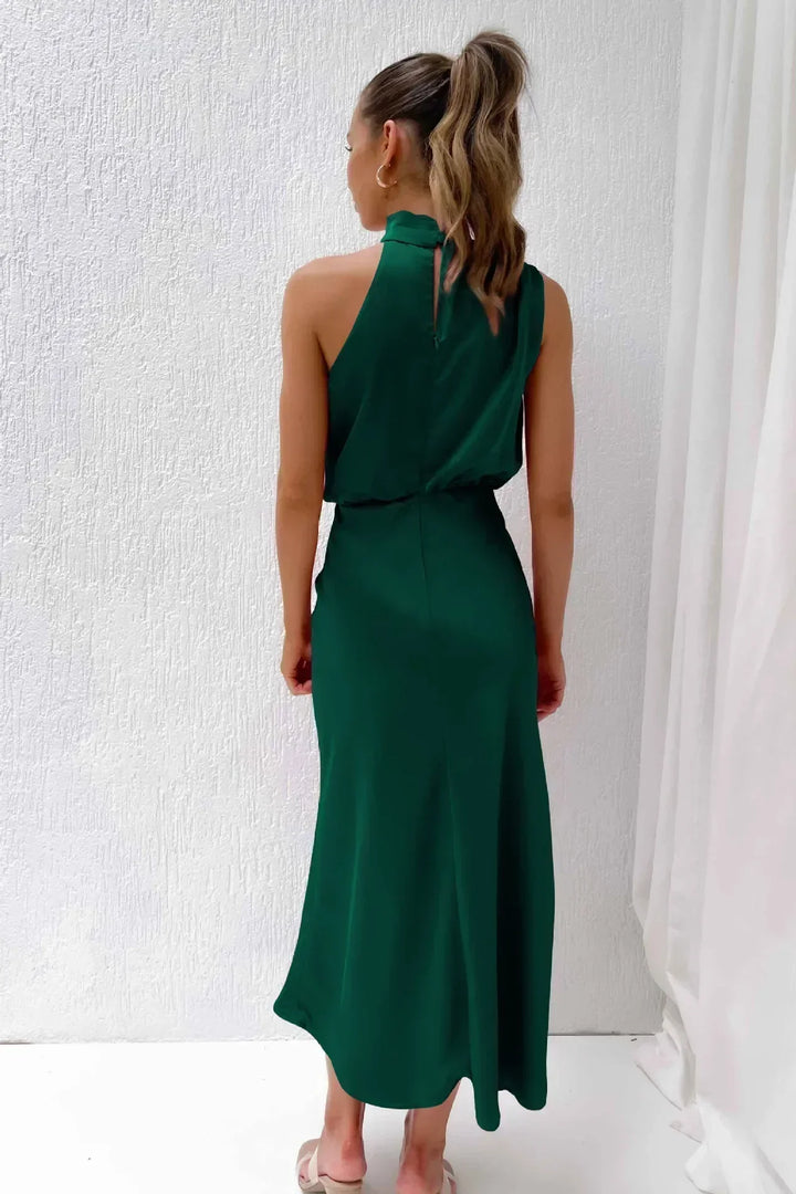 Detail of the stylish open back design on a women's formal halter evening gown, long & chic.