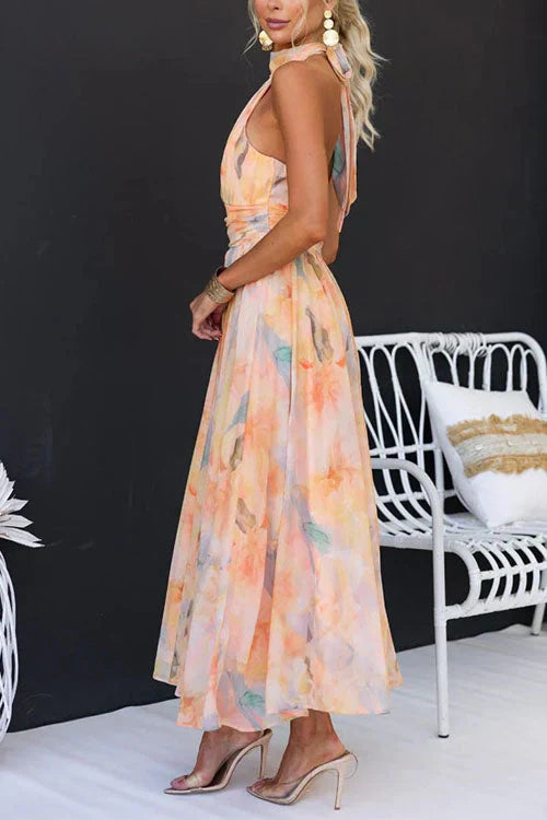 Sophisticated women's wedding guest dress, a long elegant halter maxi gown with an open back for formal events.