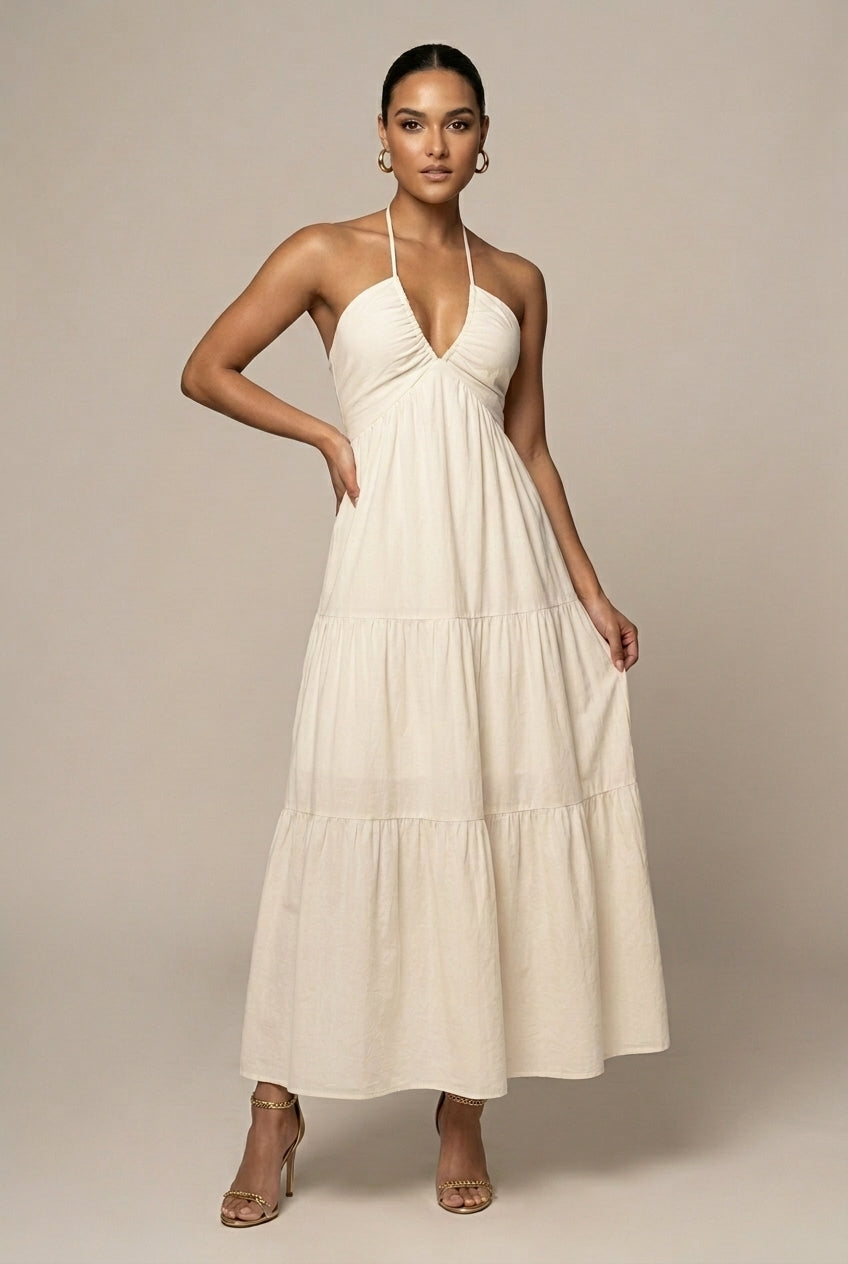 Elegant women's halter neck maxi dress with tiered ruffle skirt, open back, and tie waist, perfect for summer events.
