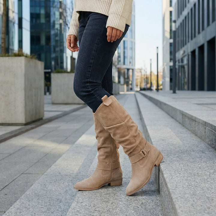 Elegant women's knee-high boots with a low heel and side zipper, perfect for fall and winter fashion.