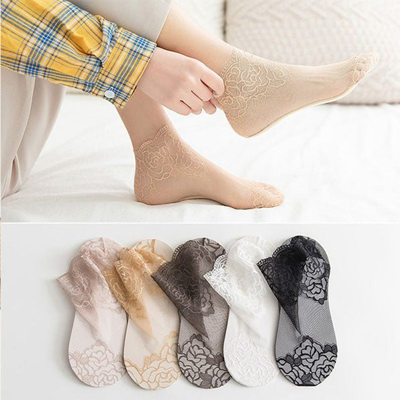 Side view of a foot wearing a sheer lace mesh ankle sock with subtle floral accents.