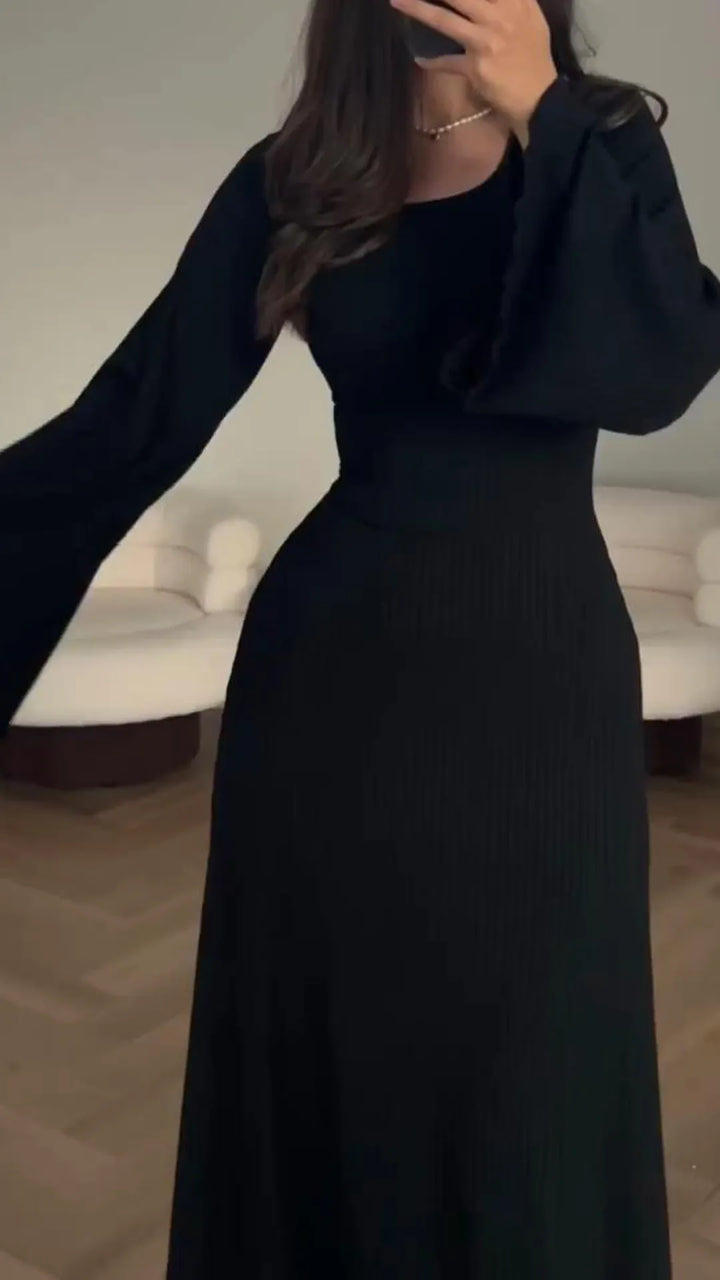 Figure-hugging long sleeve bodycon maxi dress with lace-up detail, flattering for party wear.