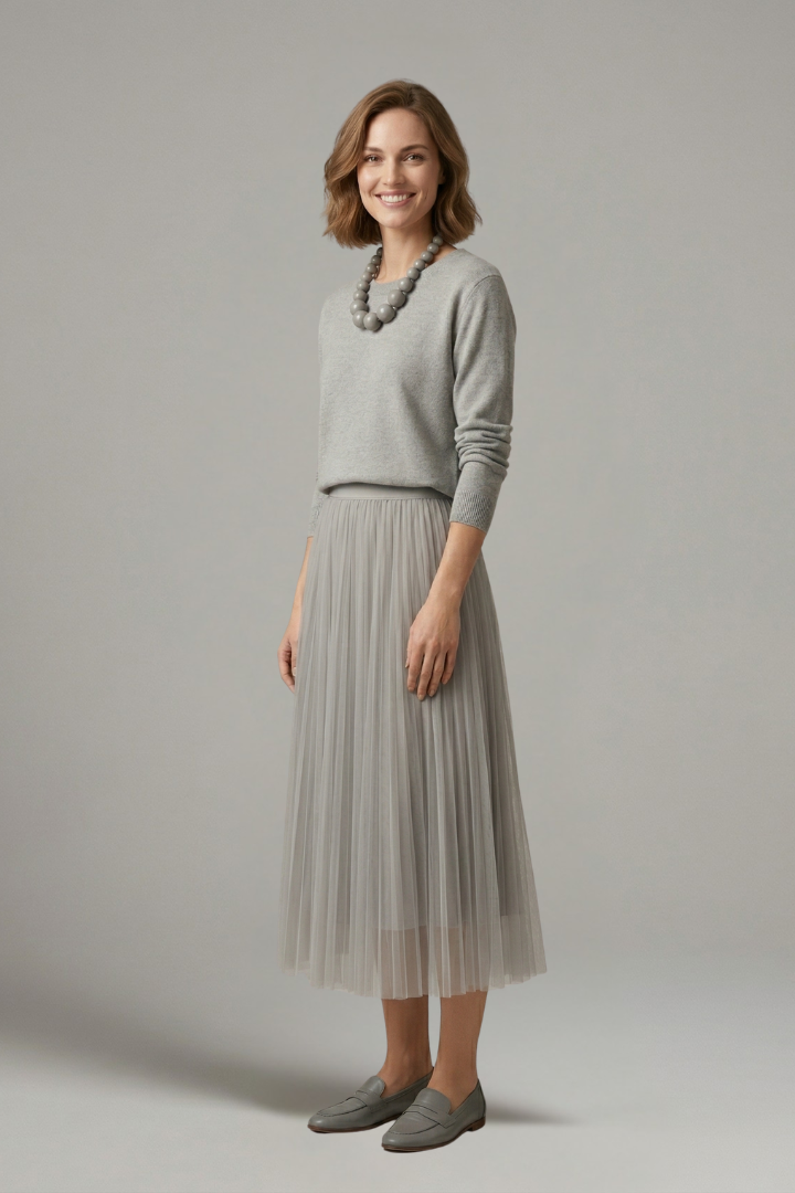 Sophisticated women's layered dress showcasing a beautifully pleated midi skirt. Elegant for any formal or casual event.